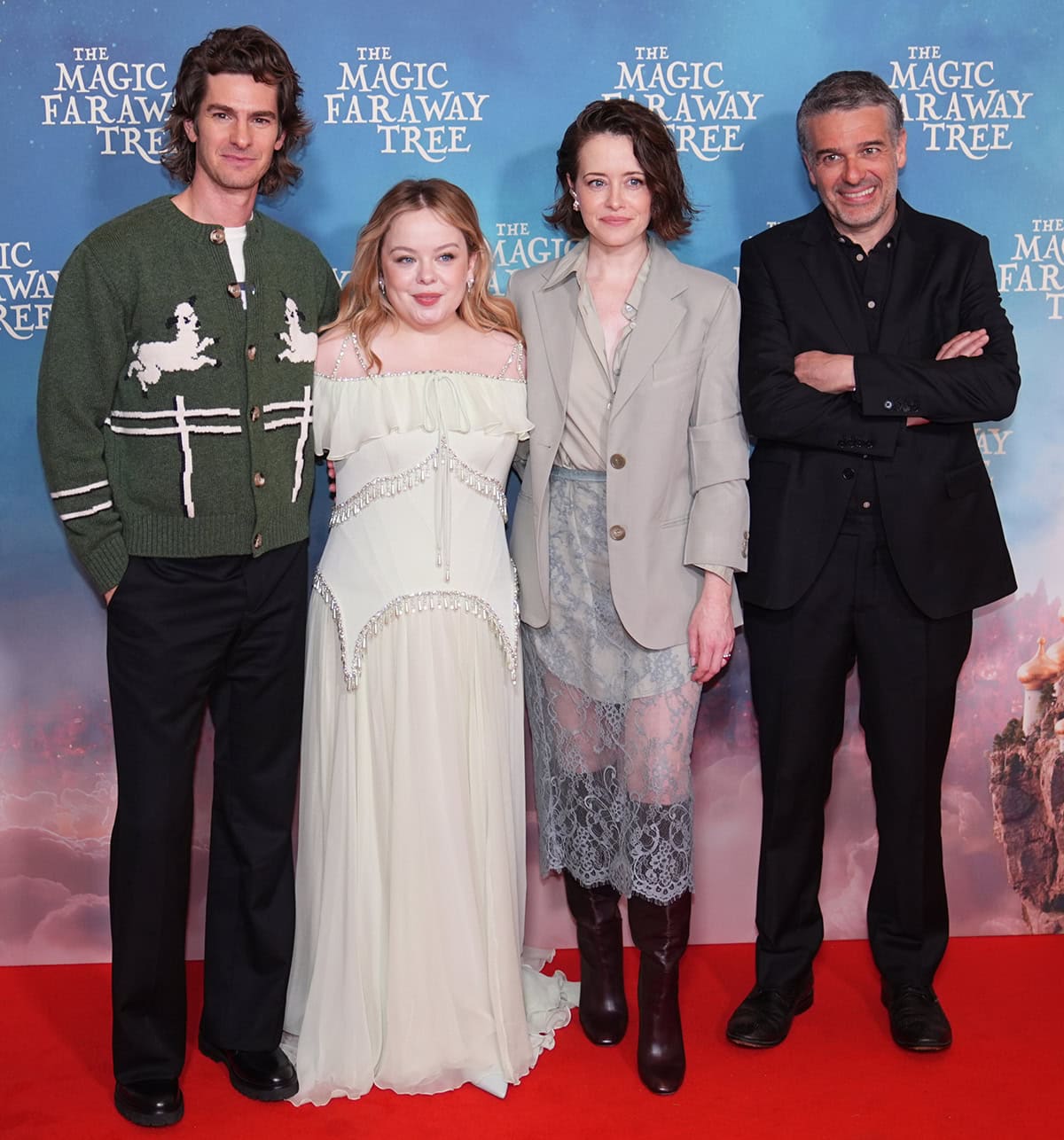 Andrew Garfield, Nicola Coughlan, Claire Foy, and director Ben Gregor attend The Magic Faraway Tree screening at Odeon Luxe Leicester Square in London on March 22, 2026, with Garfield’s chunky leather shoes and Foy’s knee-high boots anchoring the group’s mix of relaxed tailoring and ethereal dressing