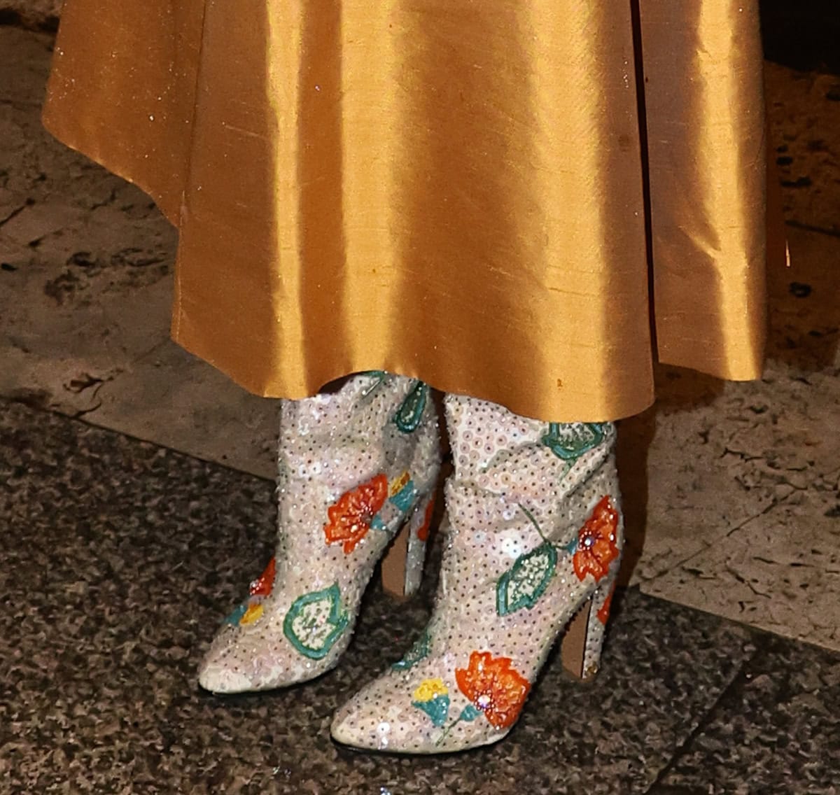 Britt Lower looks spring-ready in a pair of white Valentino boots, embellished with tiny crystals and colorful flowers in orange, green, blue, and yellow colors