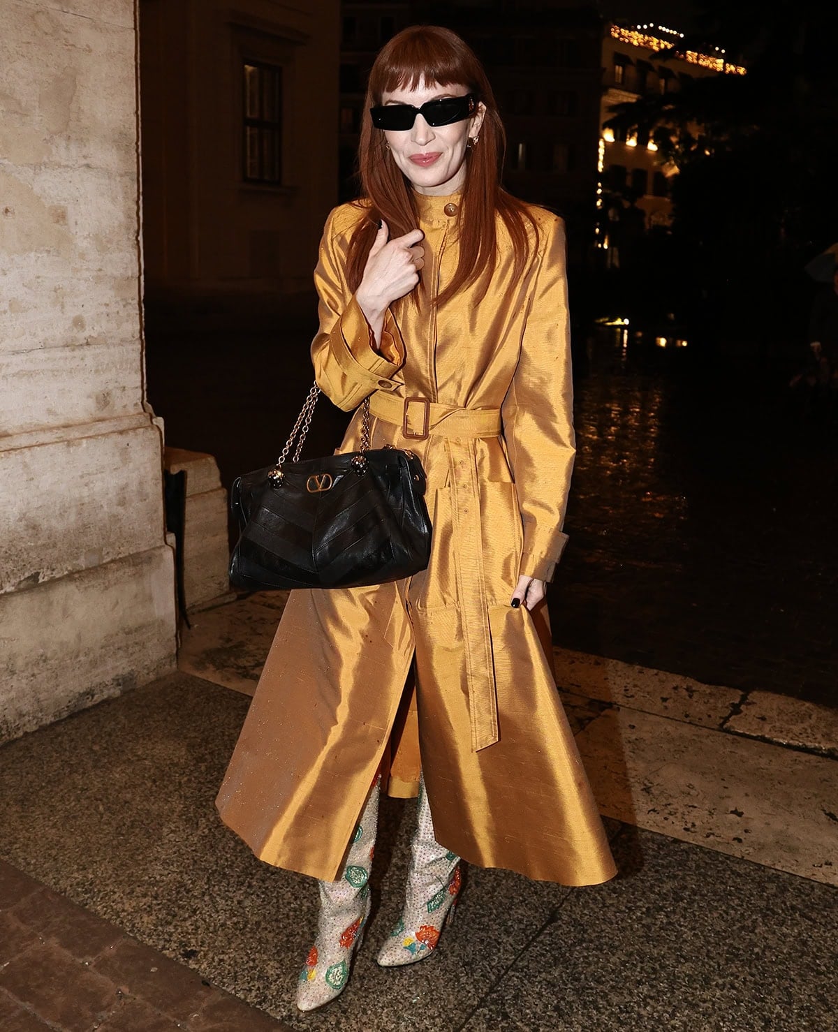 Britt Lower teams her fun, floral sequined boots with a mustard, golden-yellow trench-style midi dress