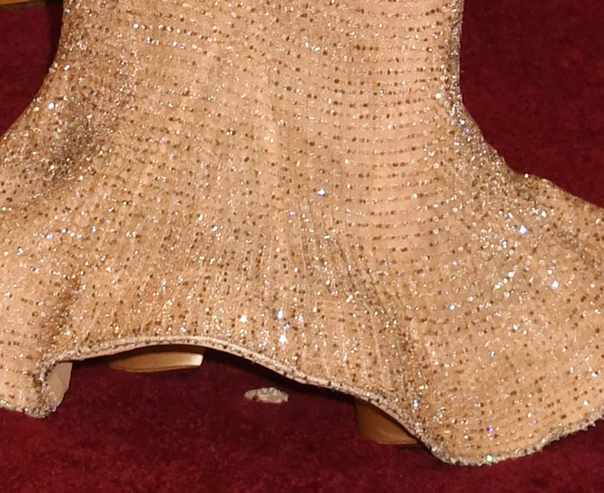 Chase Infiniti wears a pair of gold platform shoes, likely by Louis Vuitton