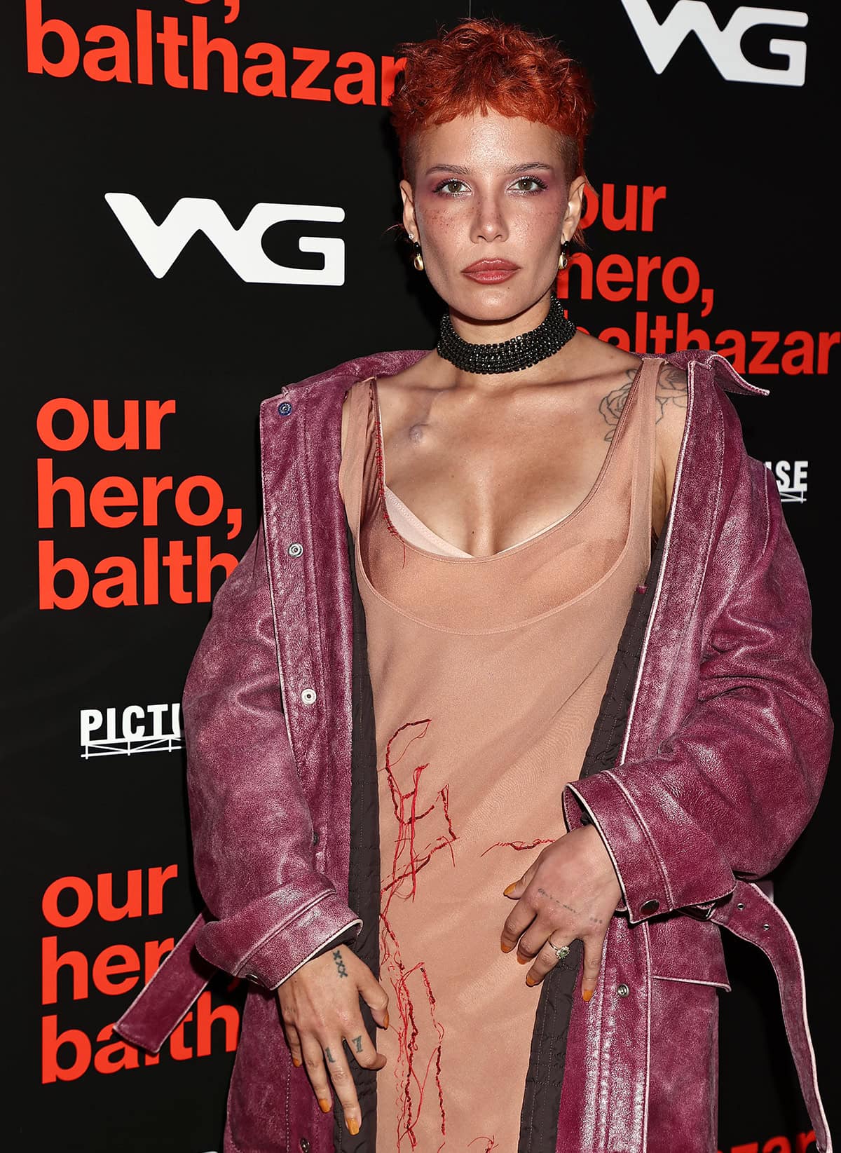 Halsey wears her textured orange pixie hair and styles her look with a crystal choker, earrings, and rings
