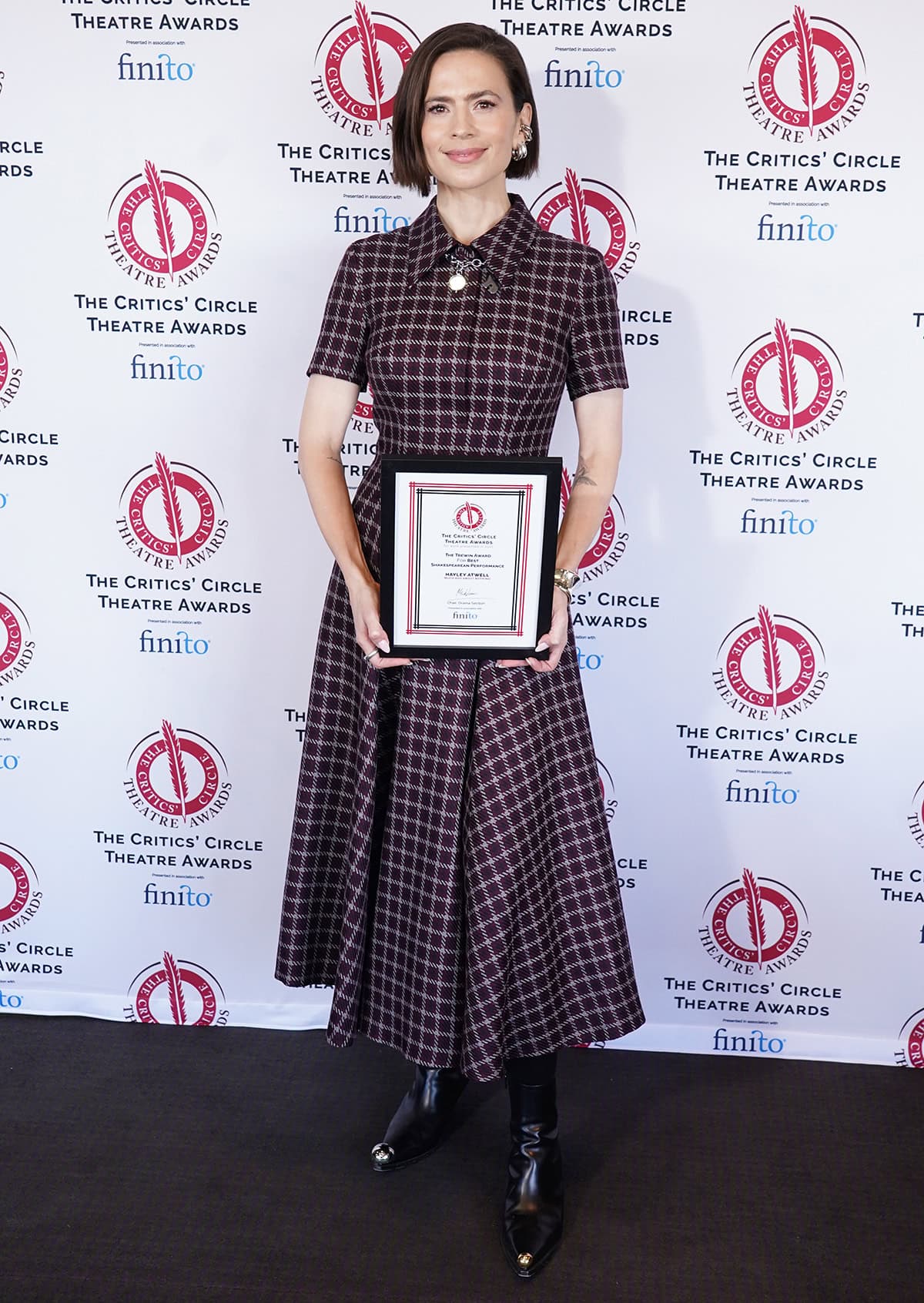 Hayley Atwell is honored with the Best Shakespearean Performance Award for her role in Much Ado About Nothing, wearing an Emilia Wickstead dress and striking boots by A.W.A.K.E. Mode at the Critics' Circle Theatre Awards 2026