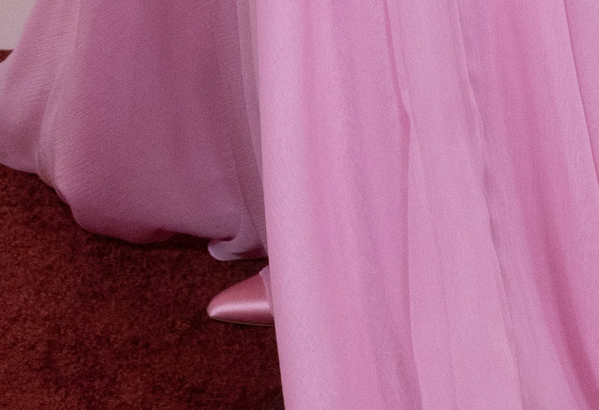 Jessie Buckley pairs her gown with pink satin pointed-toe pumps, creating a seamless look