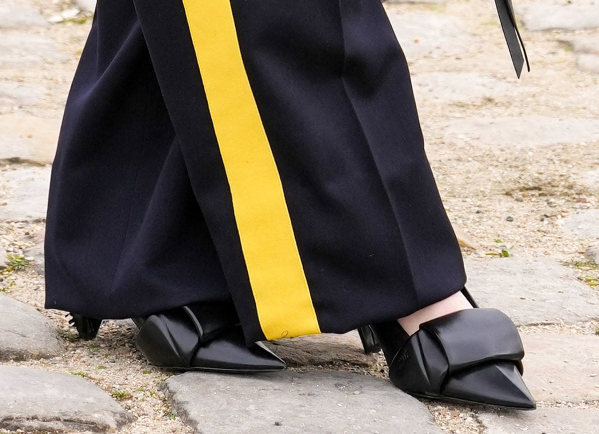 Julia Garner gives her sporty look a sophisticated touch with the Loewe “Origami” pumps featuring sculptural folds and an open-flap back design