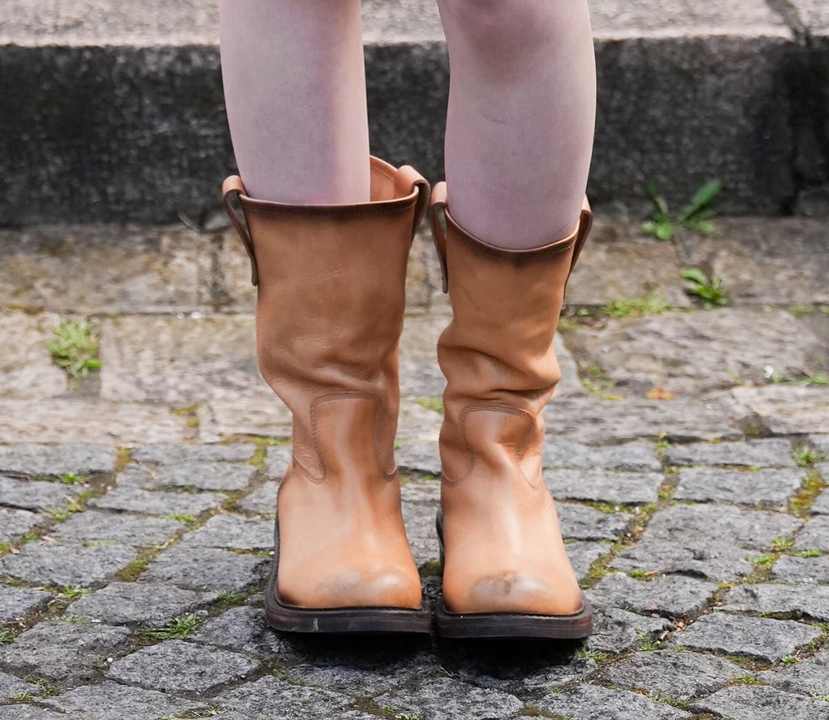 Ella Gross wears a similar look to Momo, opting for the same slouchy burnished tan leather boots