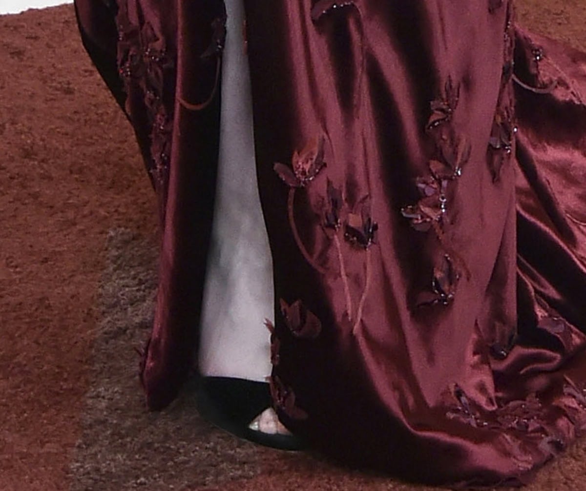 Mikey Madison slips into the black velvet Giuseppe Zanotti “Lilibeth” slingback sandals with open toes and high heels