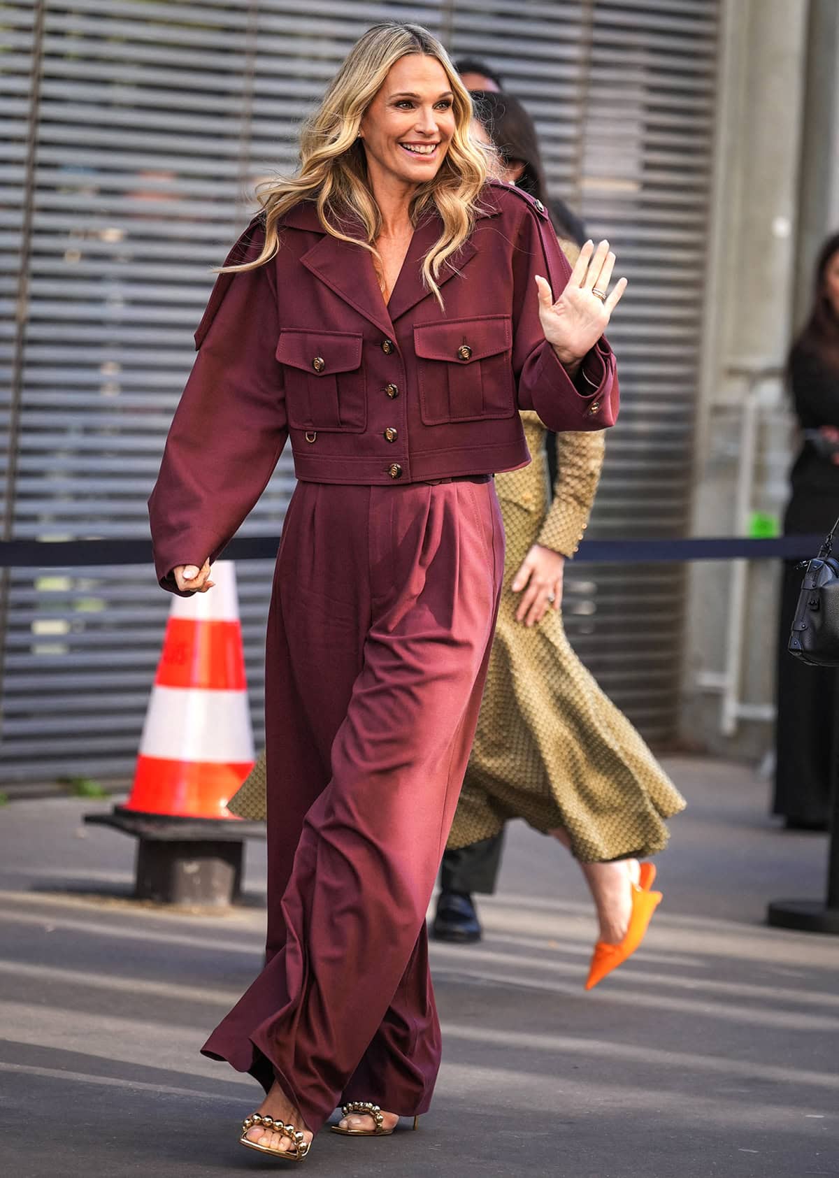 Molly Sims looks elegant, pairing her gold sandals with a mahogany cargo jacket and pants set by Zimmermann
