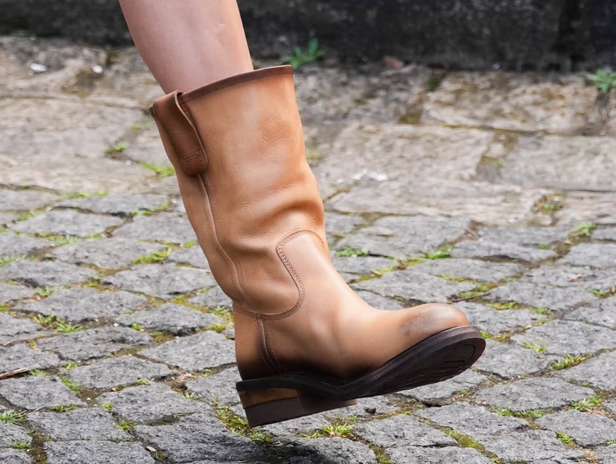 Nina Dobrev stuns in light tan foulé leather Miu Miu boots with slouchy shafts and a burnished leather finish