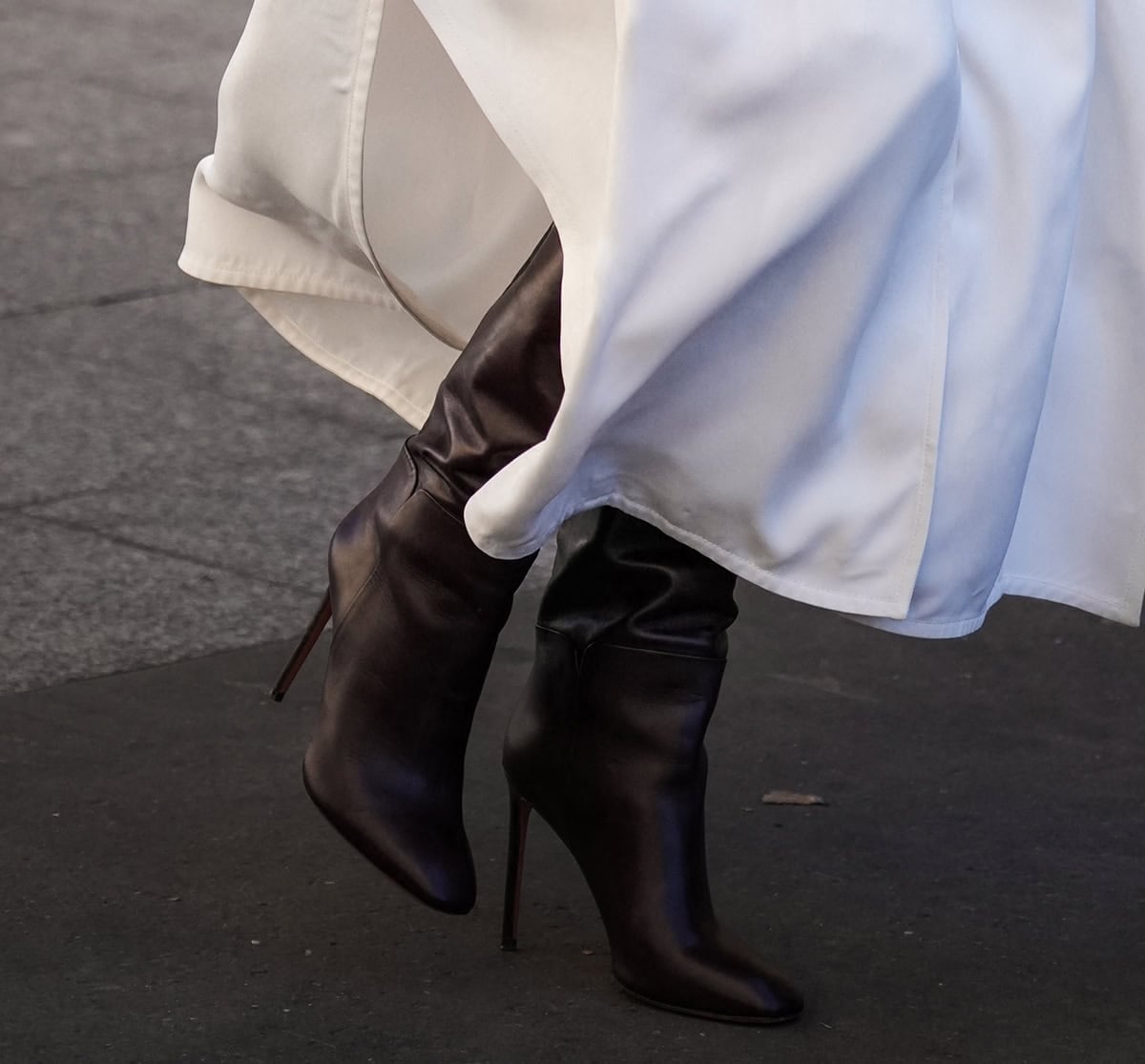 Poppy Delevingne slips into a pair of dark brown leather knee-high boots with almond toes and slim stiletto heels
