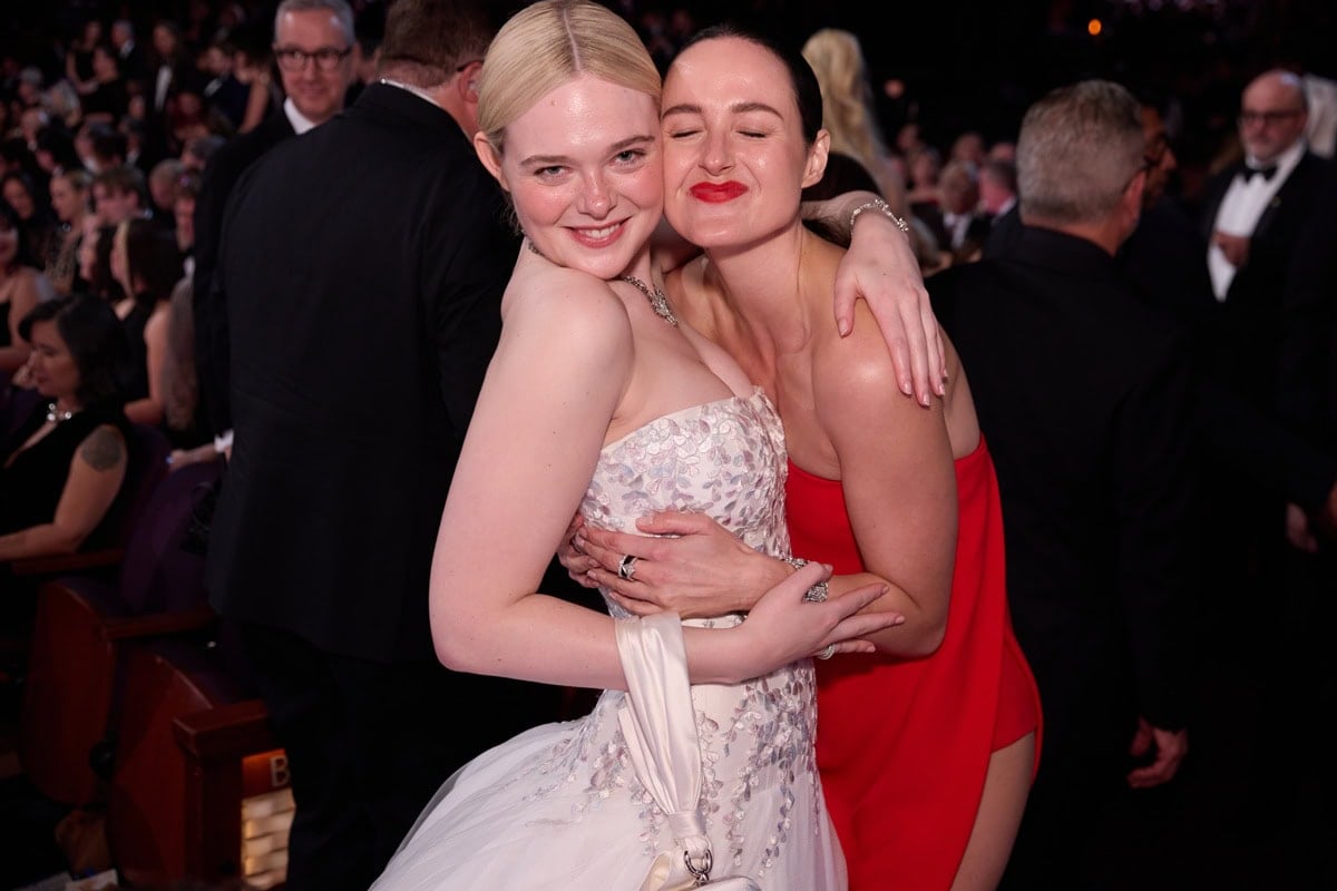 Renate Reinsve shares a joyful embrace with Elle Fanning inside the Dolby Theatre during the 2026 Academy Awards ceremony