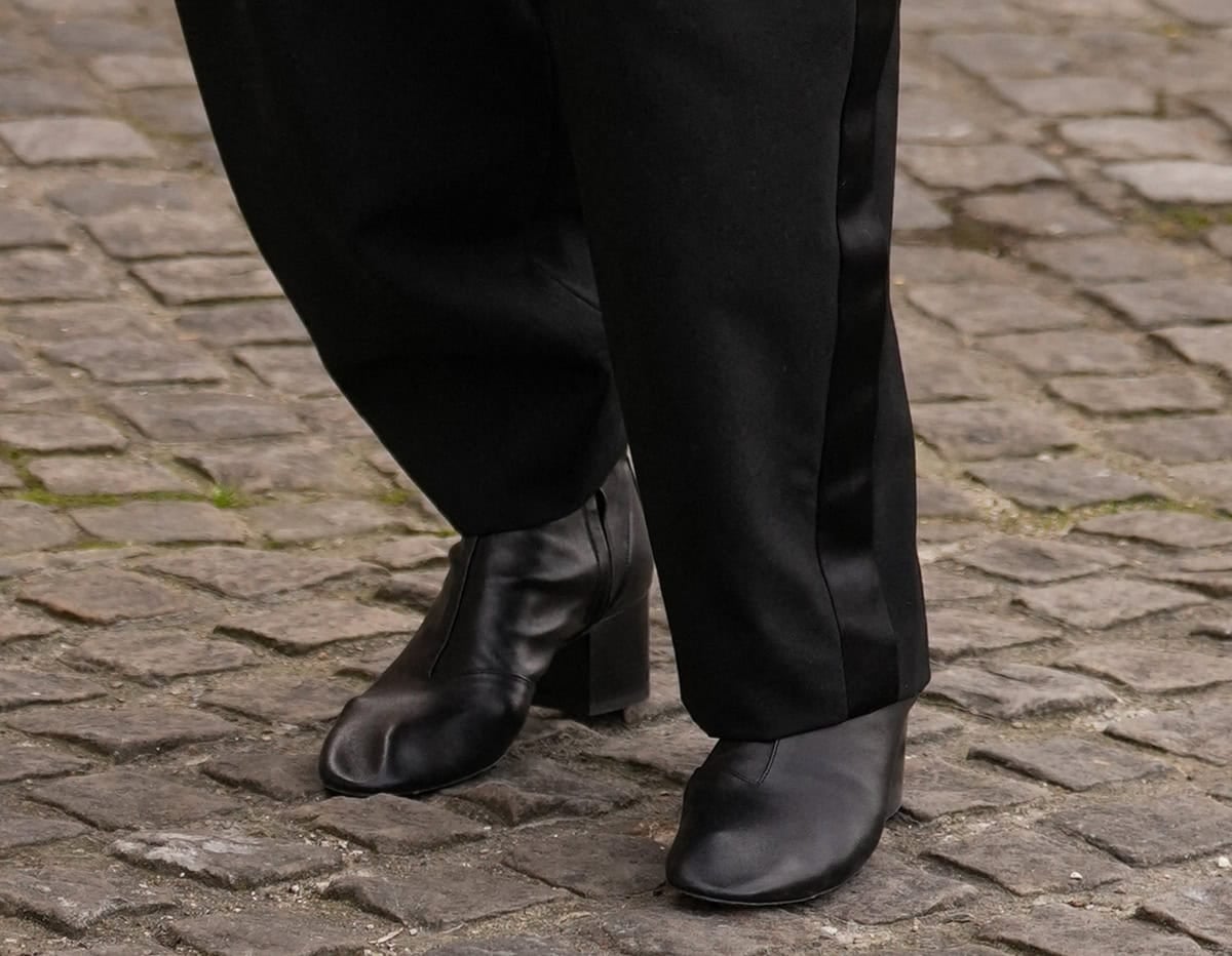 Sarah Paulson wears the black Celine “Cheri” ankle boots featuring square block heels, almond toes, and visible stitching