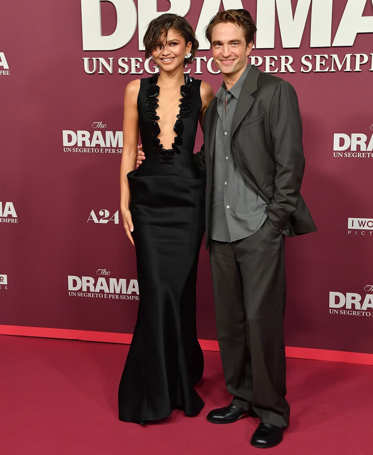 Zendaya stuns in a plunging black Armani Privé gown paired with Christian Louboutin pumps alongside Robert Pattinson at The Drama premiere at Cinema Adriano