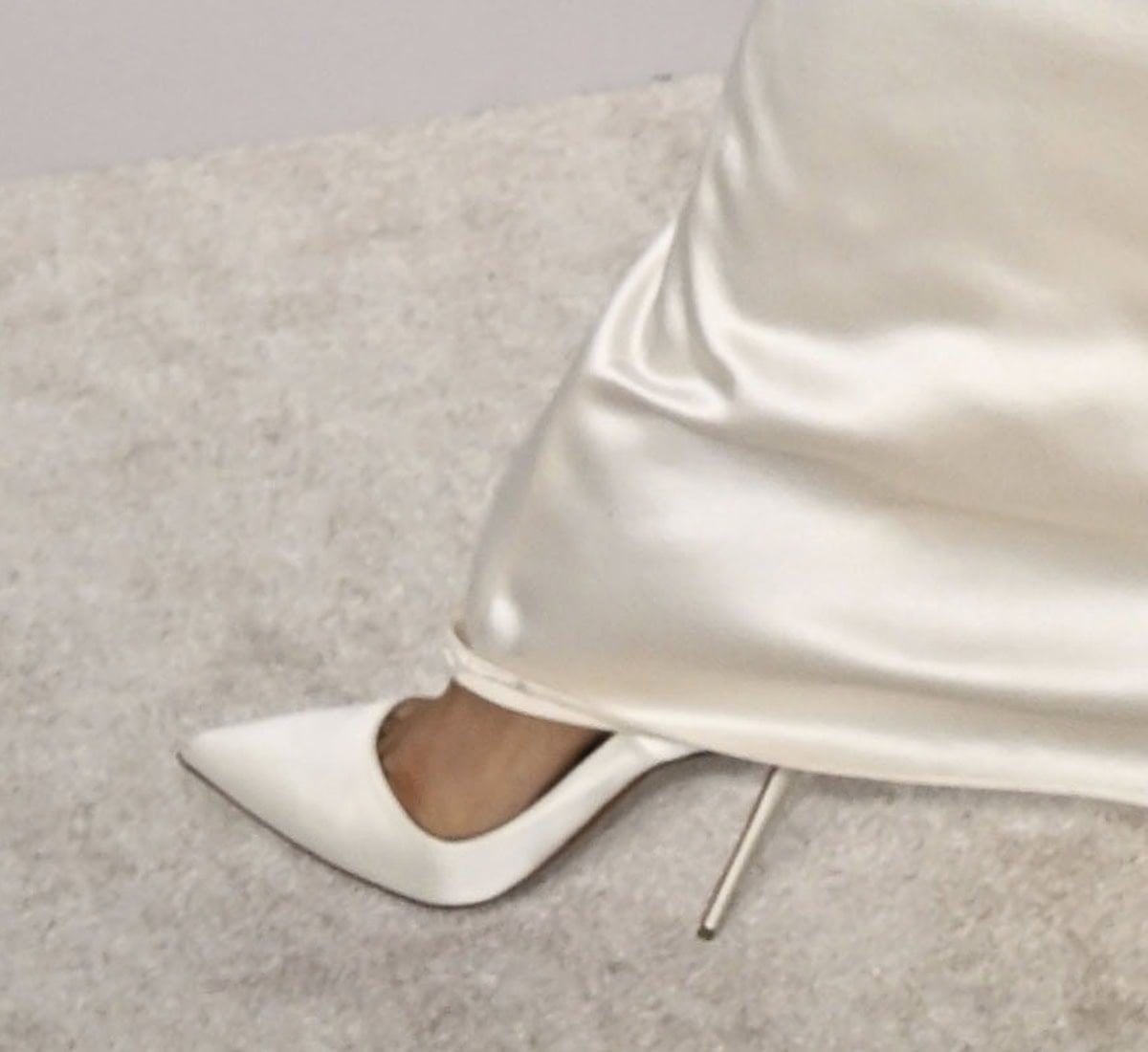 Zendaya slips into a pair of white Christian Louboutin “So Kate” pumps with sharp pointed toes and towering stiletto heels