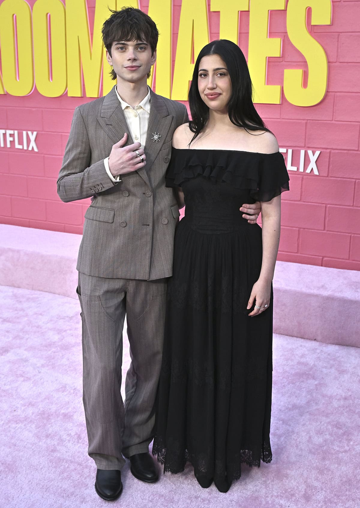 Sadie Sandler, with Aidan Langford, looks modest in a black Self-Portrait dress with a ruffled off-the-shoulder neckline, lace trims, and a lace hem