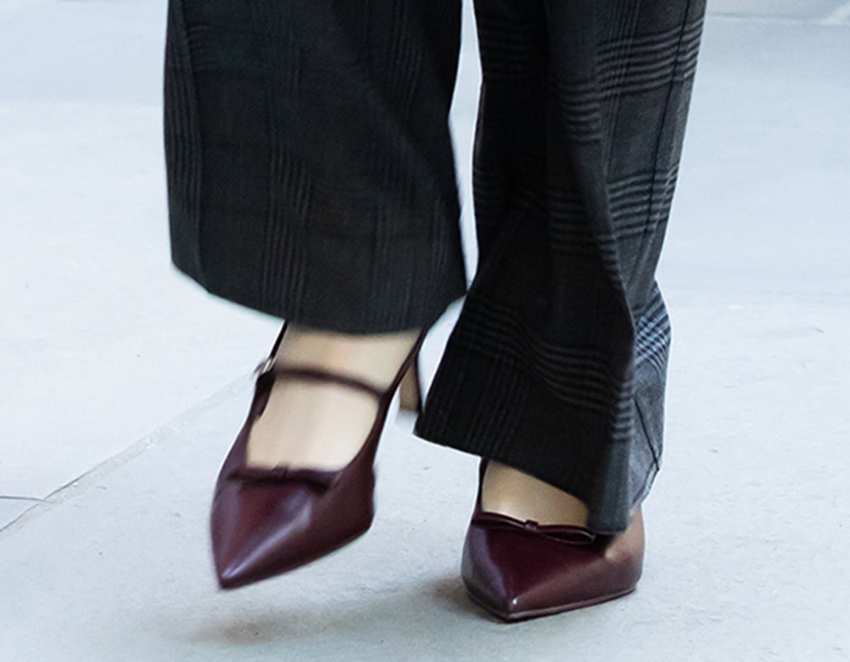 Anna Cathcart wears the burgundy Charles & Keith “Sonali” pumps featuring a bow at the vamp, pointed toes, a strap across the foot, and a slingback strap