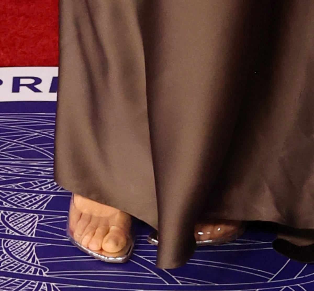 Behati Prinsloo wears a pair of clear Amina Muaddi “Alexa” mules made from transparent PVC