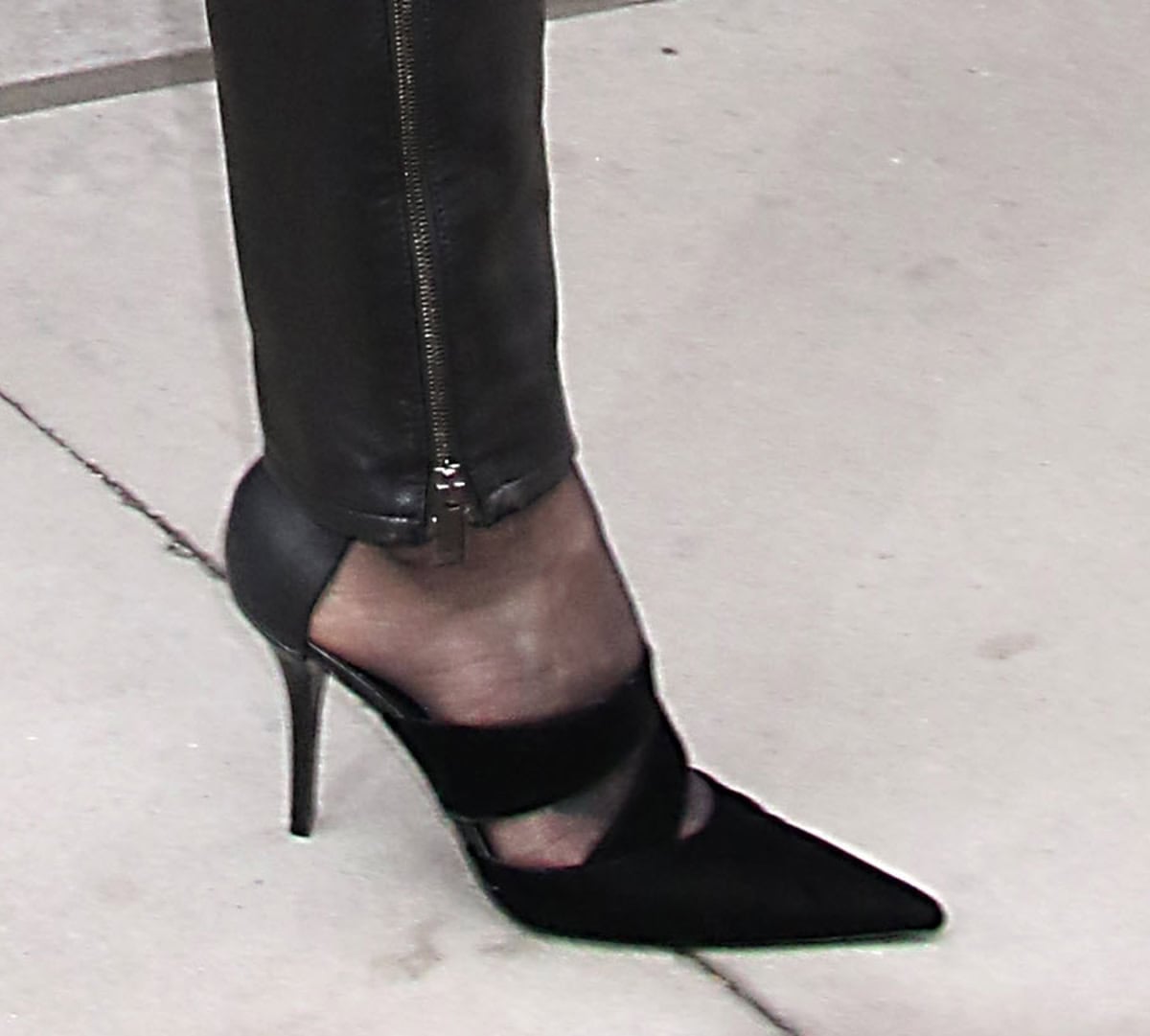 Charlize Theron opts for elevated biker chic with Balmain shoes featuring pointed toes, velour straps, and high heels