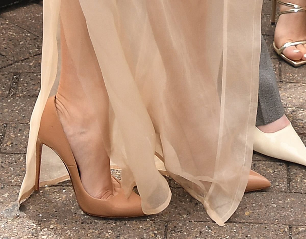 Chase Infiniti slips into a pair of tan Christian Louboutin “So Kate” pumps featuring pointed toes, low-cut uppers, and stiletto heels