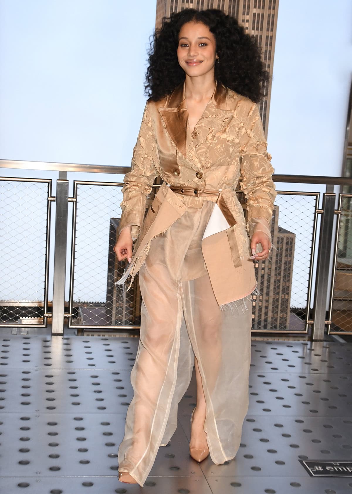 Chase Infiniti pairs her brown pumps with a deconstructed tan jacket and a see-through sheer mesh skirt by Jason Wu
