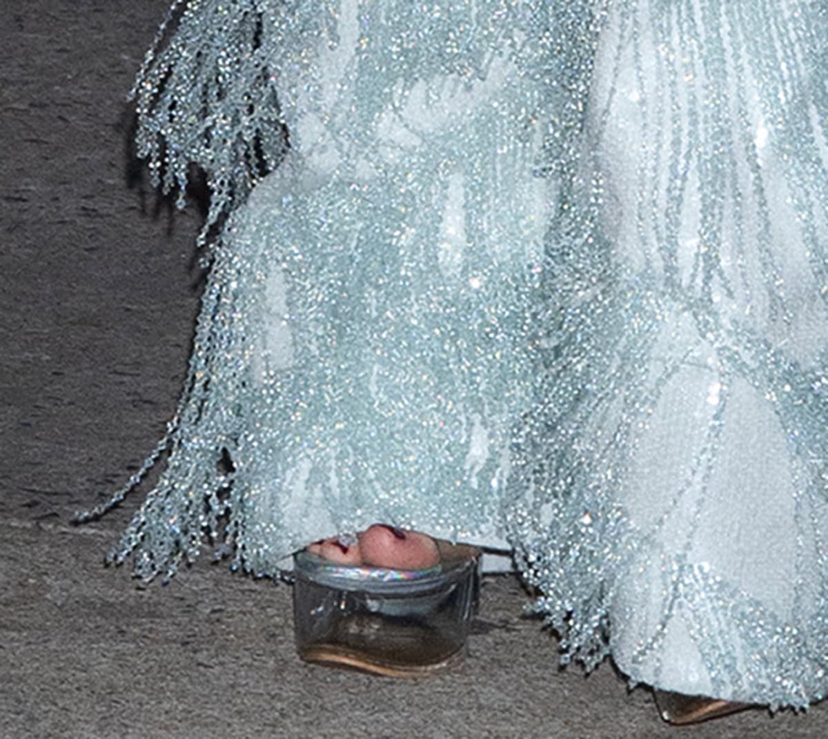 Diane Kruger slips into a pair of clear PVC sandals, featuring transparent platforms and straps