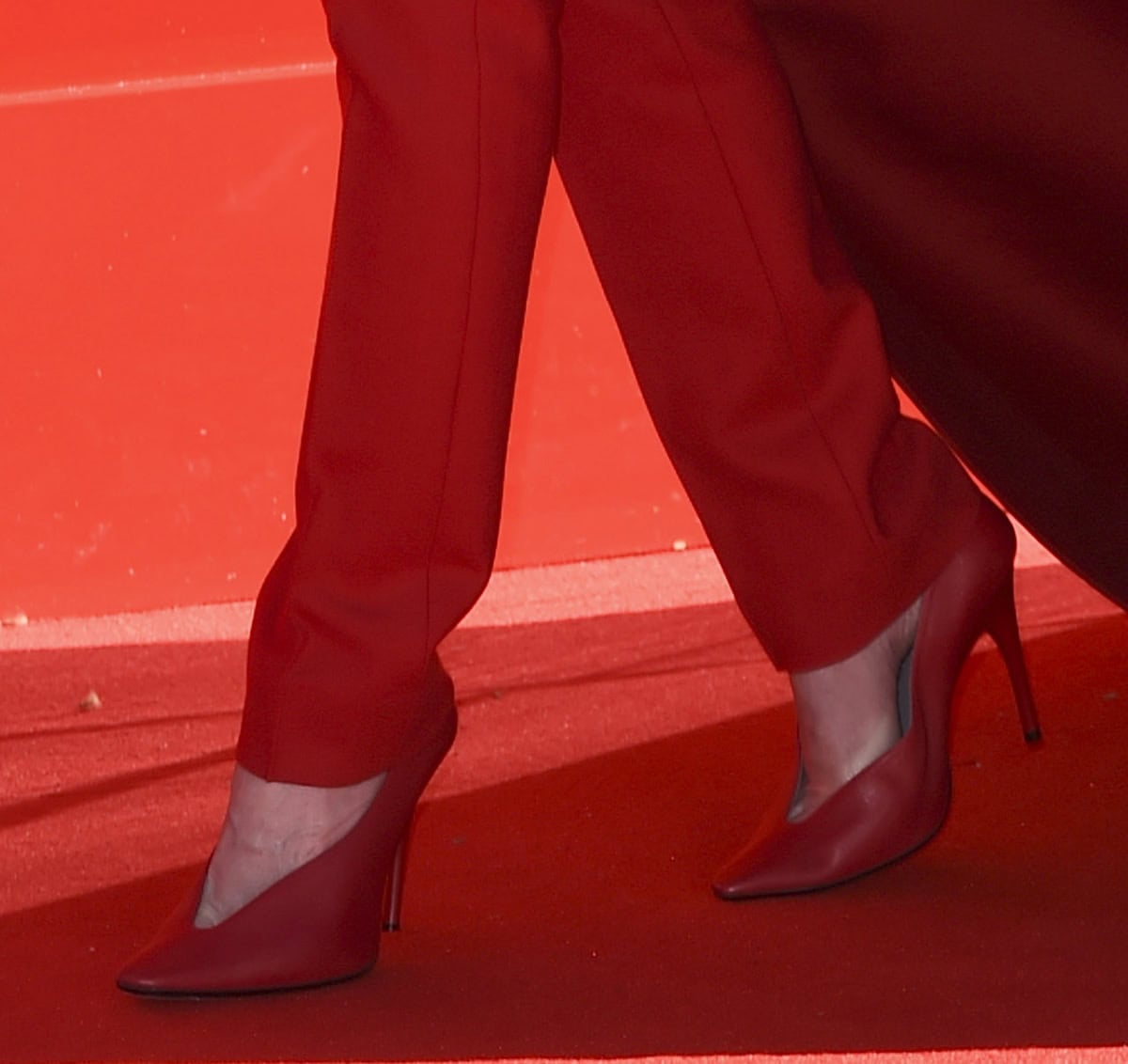 Emily Blunt slips into the trendy, architectural glove pumps by Balenciaga with V-shaped vamps, squared pointed toes, and stiletto heels