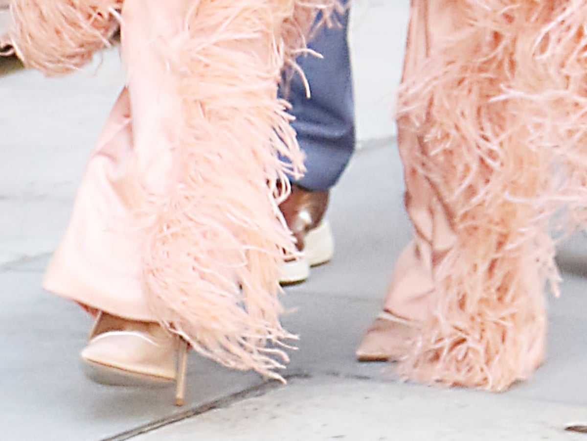 Halle Bailey slips into the Femme LA “Cobra” pumps crafted from sheer nude mesh with wraparound ankle ties