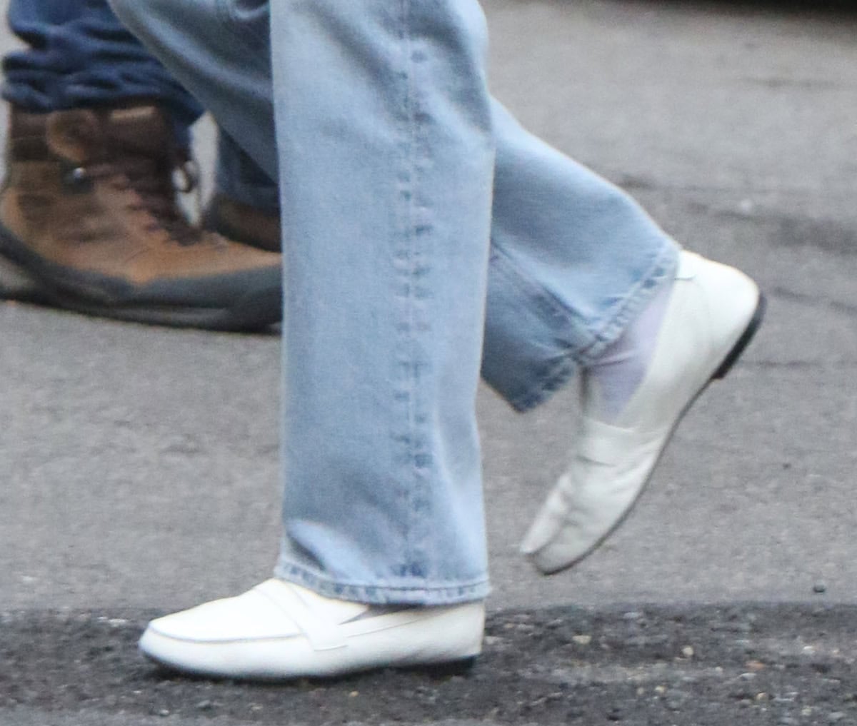 Lindsay Lohan wears a pair of versatile white leather loafers with a penny front strap and a folded tab at the back