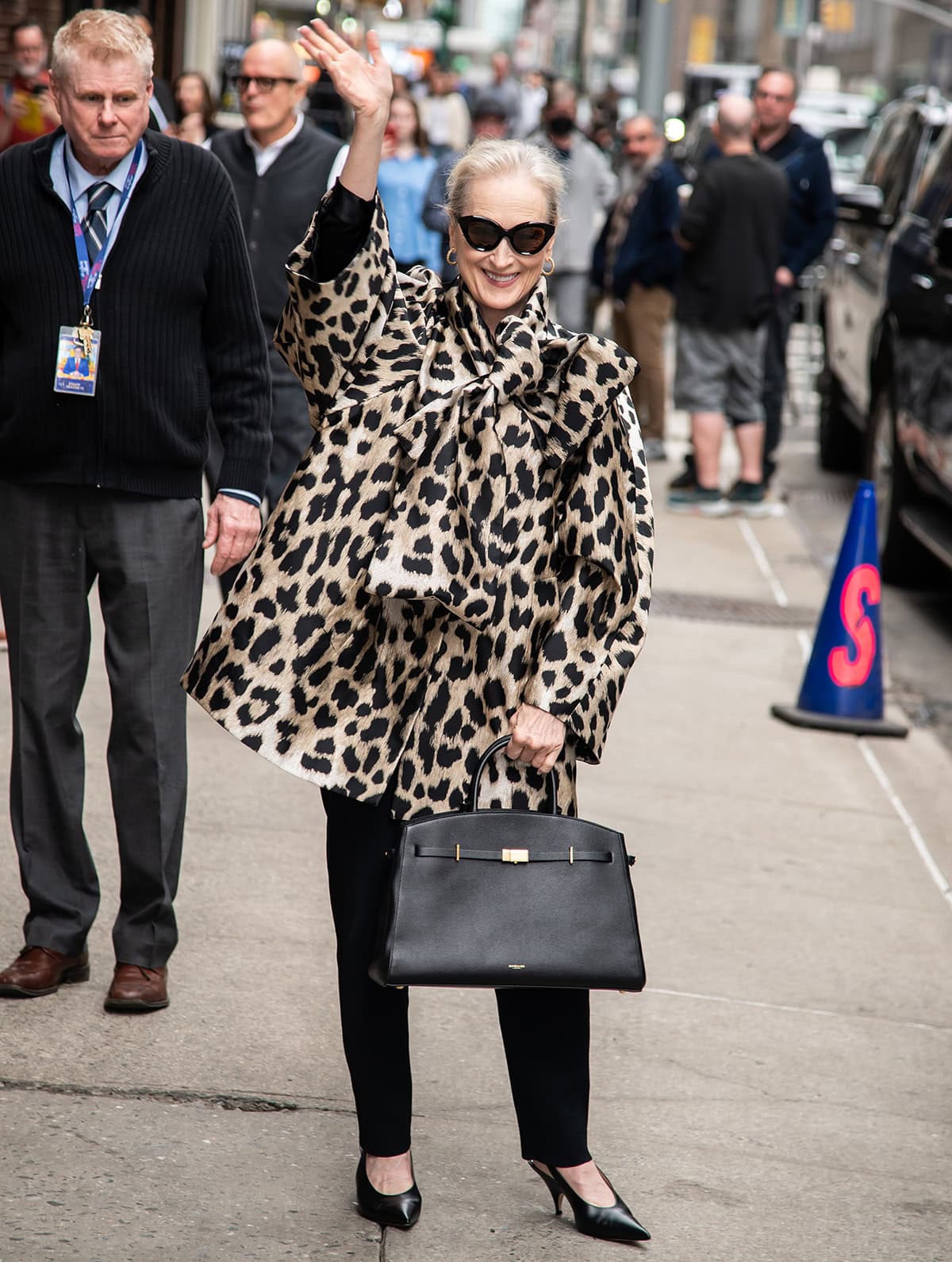 Meryl Streep pairs her slingback pumps with tapered trousers and a cheetah-print Givenchy coat with a pussybow