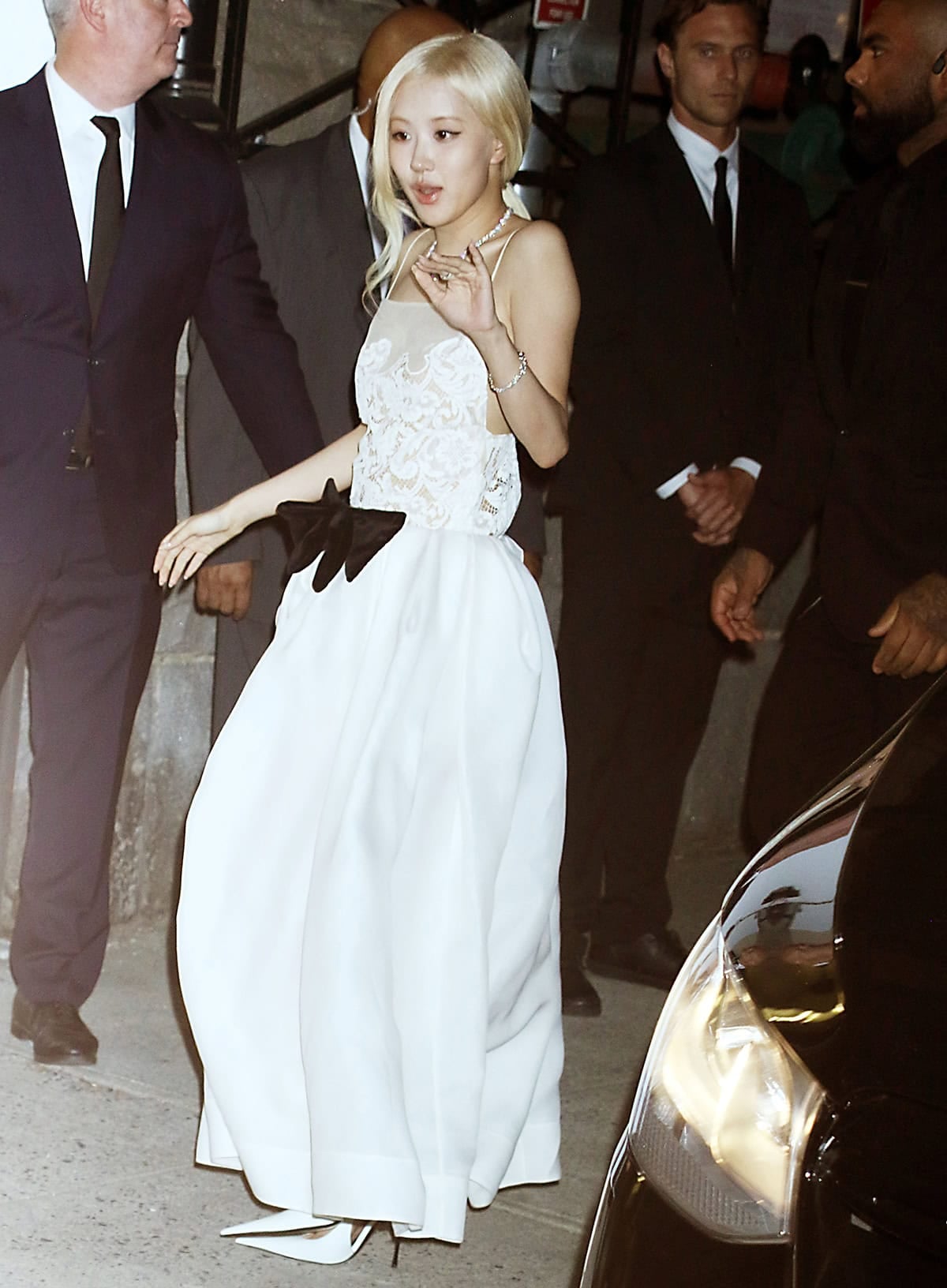 Rosé steps out in sharp white Saint Laurent slingback pumps paired with a romantic Khaite dress, featuring a delicate lace bodice and a softly structured tulip skirt