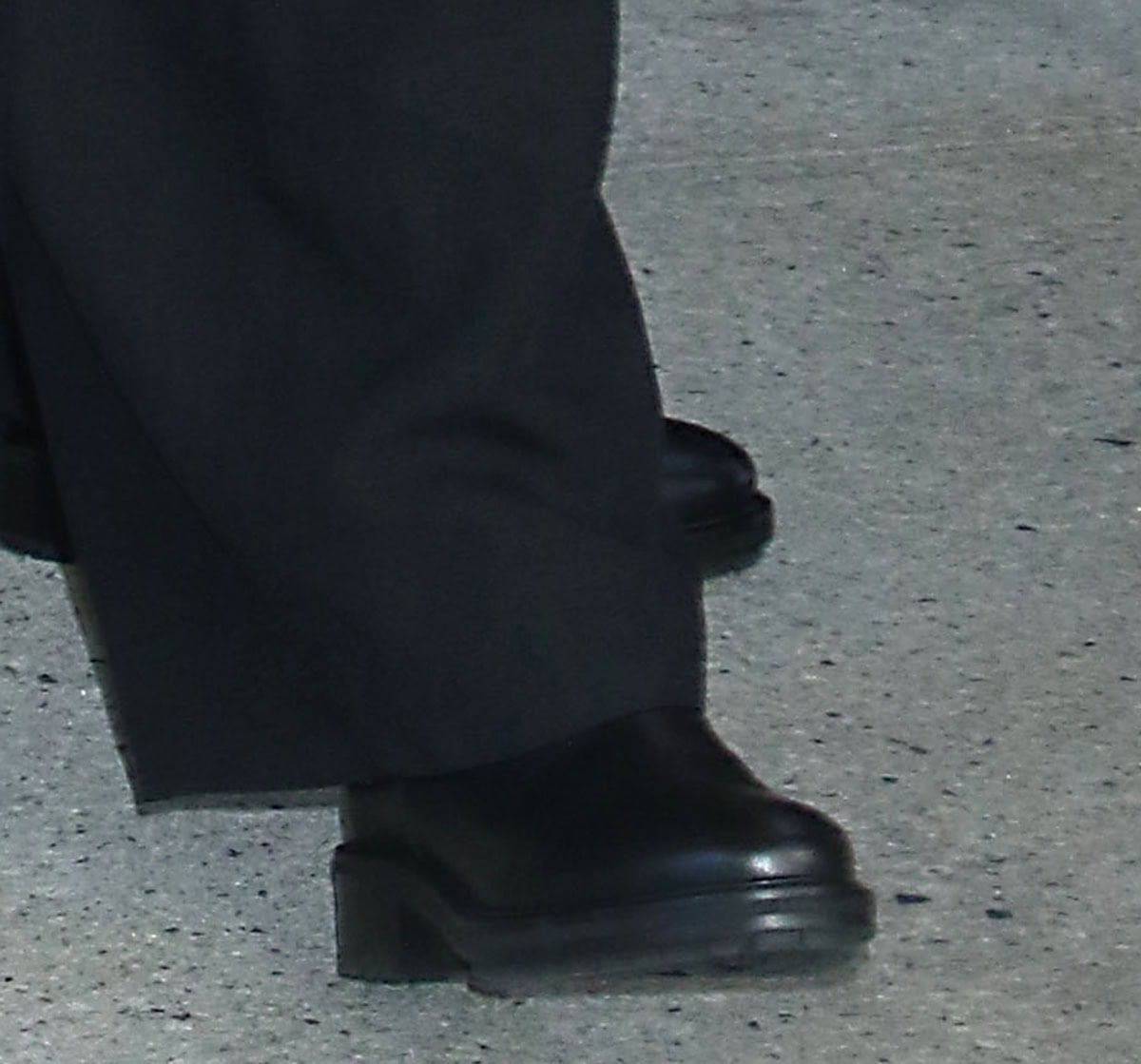 Sadie Sandler grounds her look with smooth black leather platform boots, their chunky sole and short block heel adding subtle lift to her relaxed tailoring