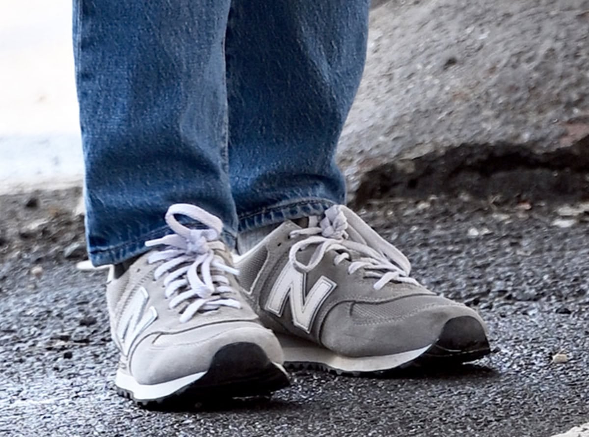 Scarlett Johansson wears the podiatrist-approved New Balance 574 sneakers in a gray-and-white colorway