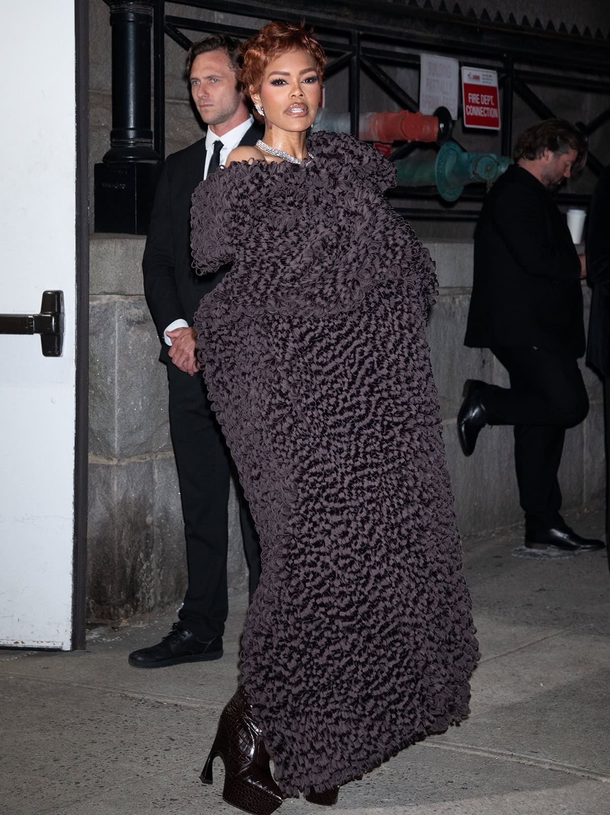 Teyana Taylor teams her croc boots with a Calvin Klein coat made of curled organza and Tiffany & Co. Blue Book 2026 high jewelry earrings and necklace