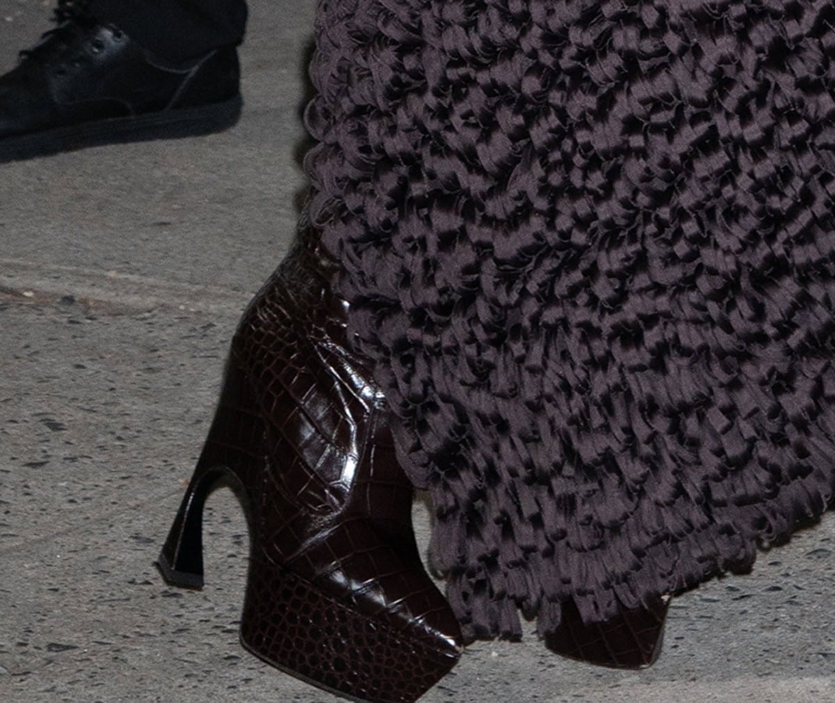 Teyana Taylor brings an edge to the event with her Bordeaux croc-effect leather boots by Victoria Beckham with sharp pointed toes, platforms, and sculptural curved heels