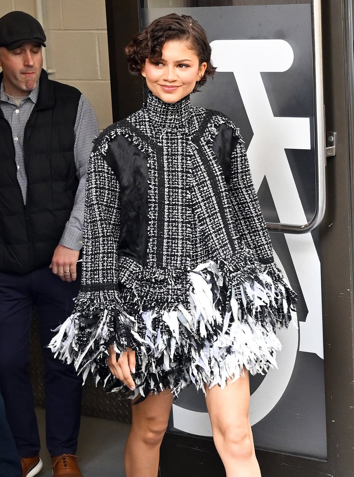 Zendaya styles her bixie in soft, side-parted curls, pairing the sculpted cut with barely-there makeup that lets her natural features take focus