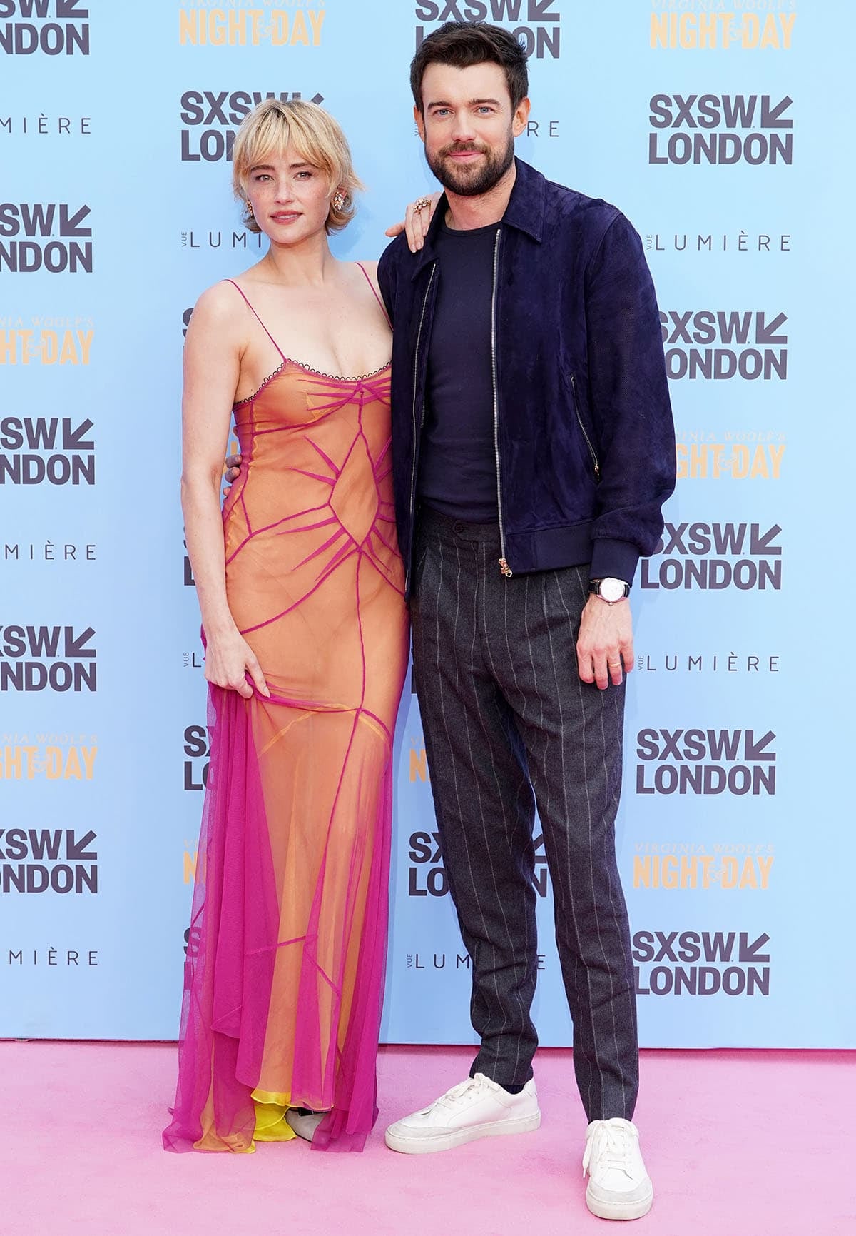 Haley Bennett brings avant-garde romance to the Virginia Woolf’s Night and Day world premiere in a pink-and-yellow Viktor Gichev gown, grounding the ethereal look with sculptural gray Manolo Blahnik Bukla pumps as she poses alongside co-star Jack Whitehall