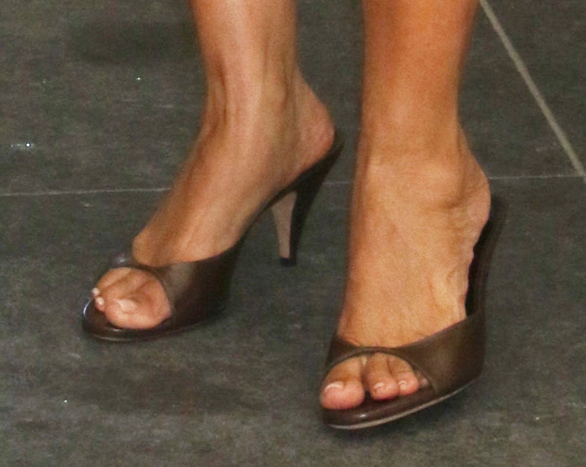 Tracee Ellis Ross keeps things light and summery in Jude “Haze” mules in mocha leather featuring a cutout upper and sculpted tapered heels